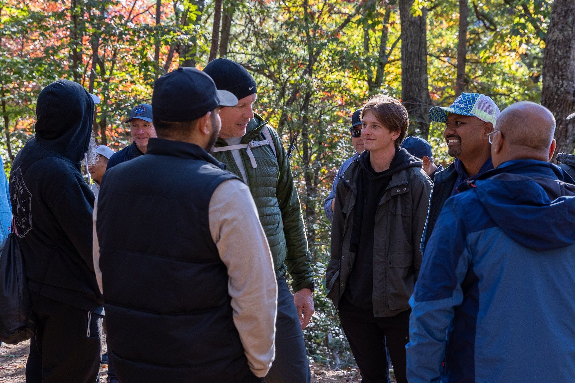 CISO Ascent retreat participants pause for conversation on a forest trail in Asheville