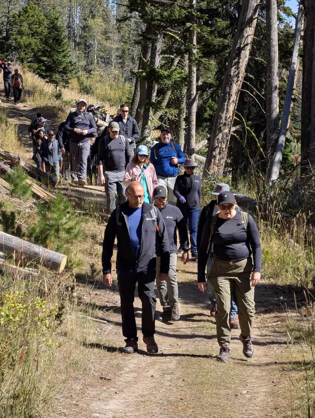 Retreat members hiking together along a forested trail